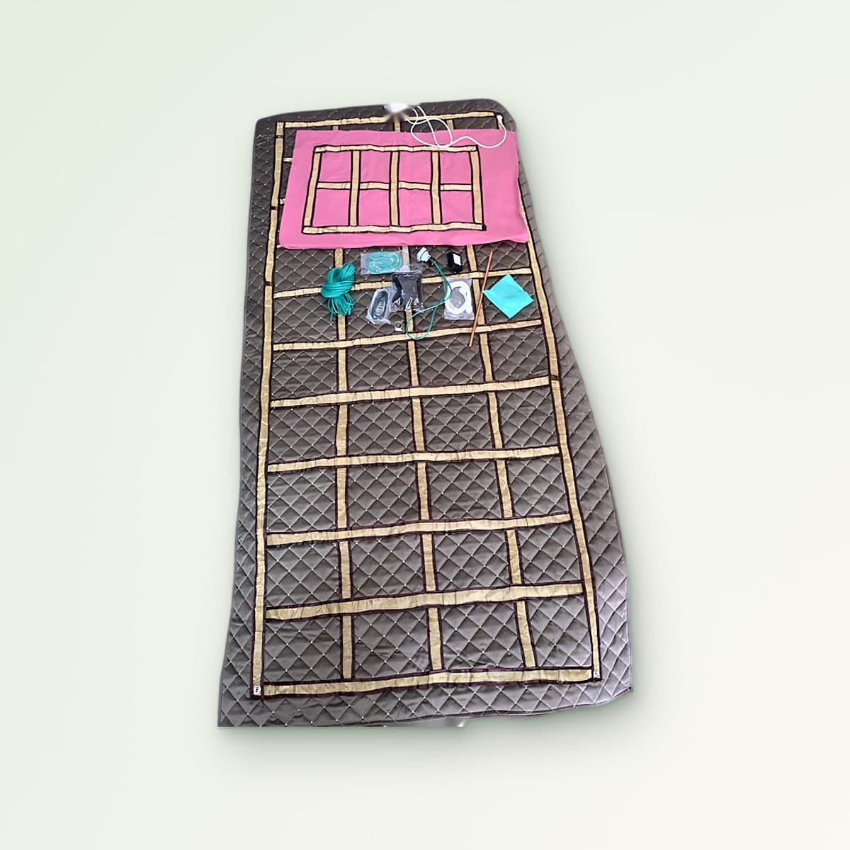 Zero Volt Pillow and Bedsheet combo: quilted bedsheet with a pink pillow cover and the earthing cords, tester, connector wires and copper rod
