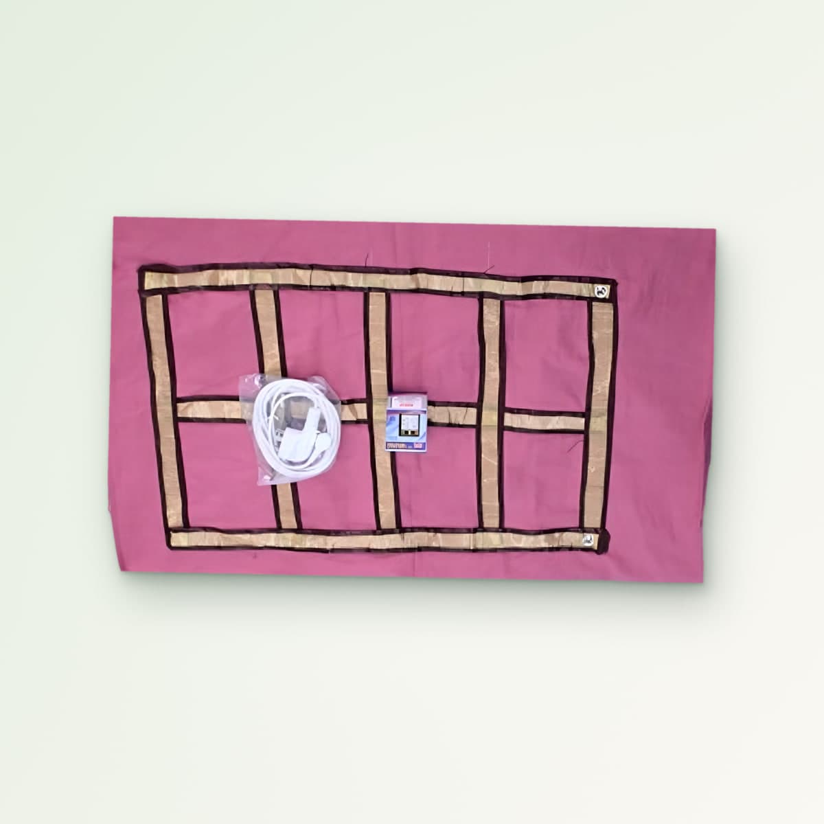 Zero Volt Pillow Cover: pink earthing pillow cover with a brass-coloured conductive grid, earthing cord and tester